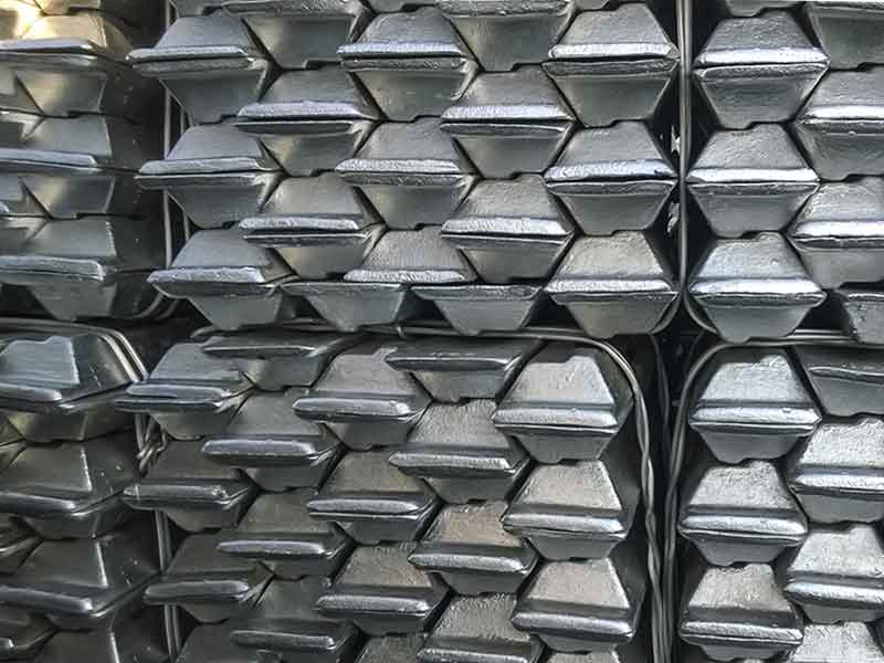 Stacked bars of aluminium as an example for the product of aluminium electrolysis with anode paste.