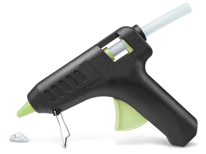 Hot glue gun with drop of an adhesive