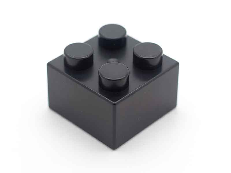 Black Lego brick as an example for masterbatch / compounding systems